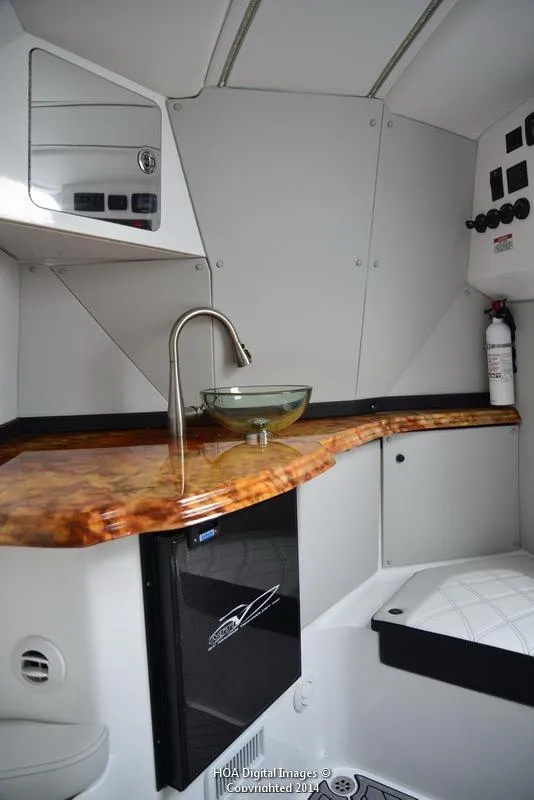 Slide: The Image of 2025 MTI V Marine Technology Inc V 42 boat interior with kitchenette and seating area. - 20