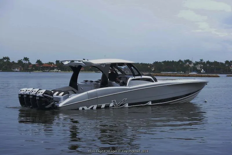 Slide: The Image of 2025 MTI V Marine Technology Inc V 42 boat on calm water. - 24
