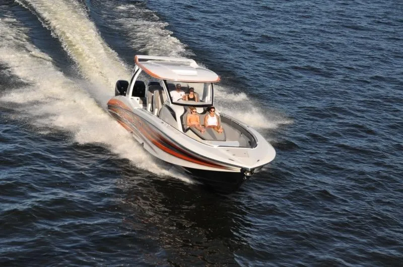 Slide: The Image of 2025 MTI V Marine Technology Inc V 42 boat cruising on open water. - 27