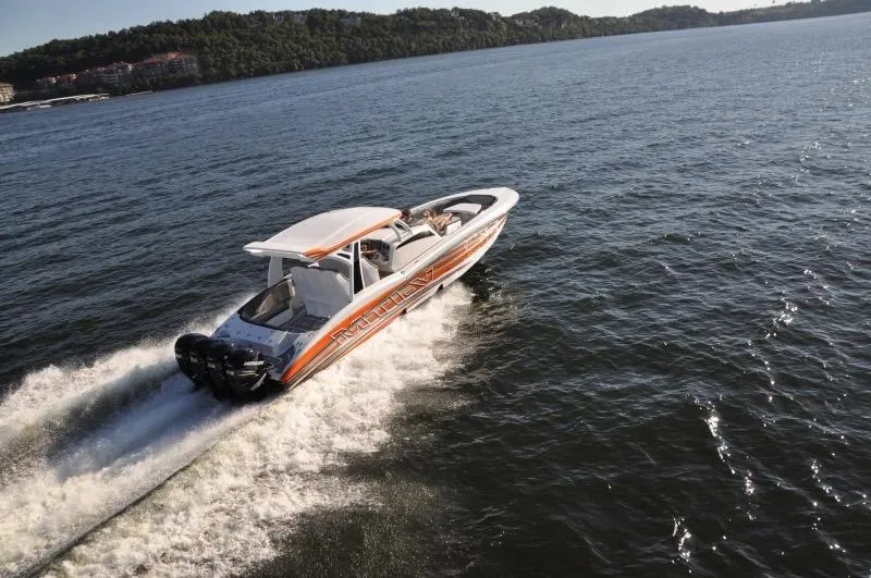 Slide: The Image of 2025 MTI V Marine Technology Inc V 42 speedboat cruising on open water. - 28