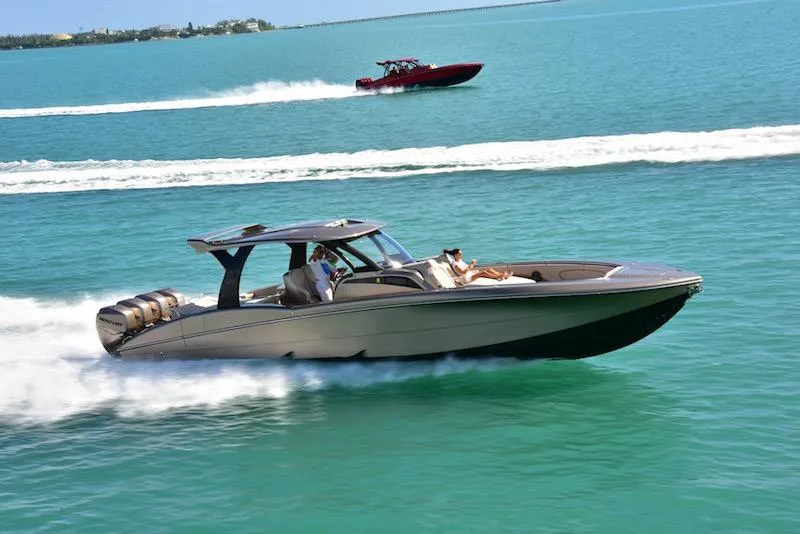Slide: The Image of 2025 MTI V Marine Technology Inc V 42 speedboat cruising on clear blue water. - 3
