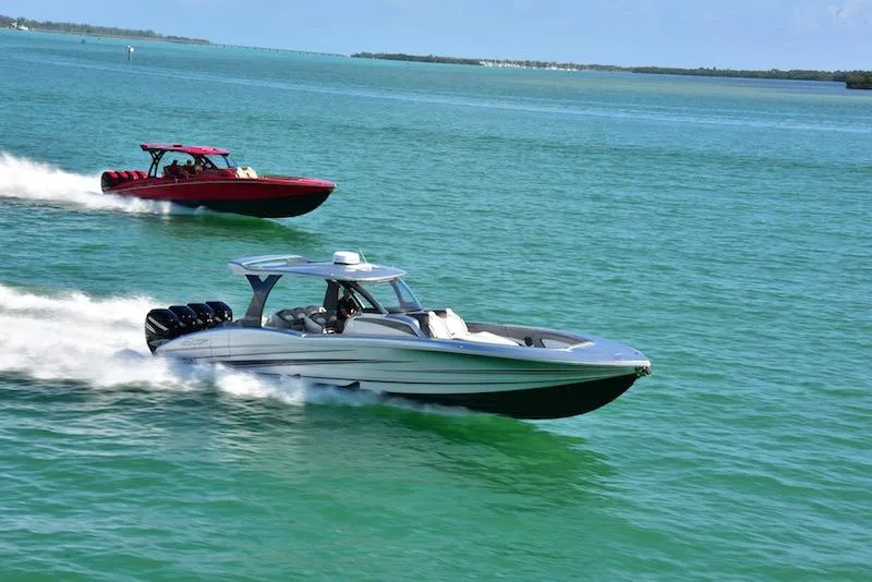 Slide: The Image of Two MTI V 42 boats speeding on clear blue water, 2025 model. - 5