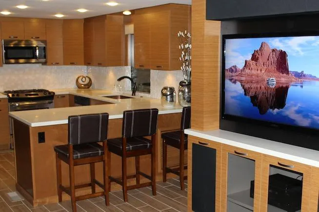Slide: The Image of Modern kitchen with wooden cabinets, stainless steel appliances, and white countertops. - 2