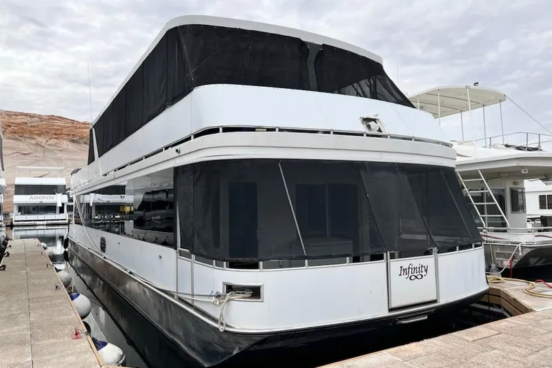 The Image of Luxury Bravada houseboat "Infinity Trip #8" docked, 2014 model, with sleek design and spacious decks. - 0
