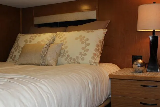 Slide: The Image of Cozy bedroom interior in 2014 Bravada Infinity Trip #8 with elegant bedding and wooden accents. - 12