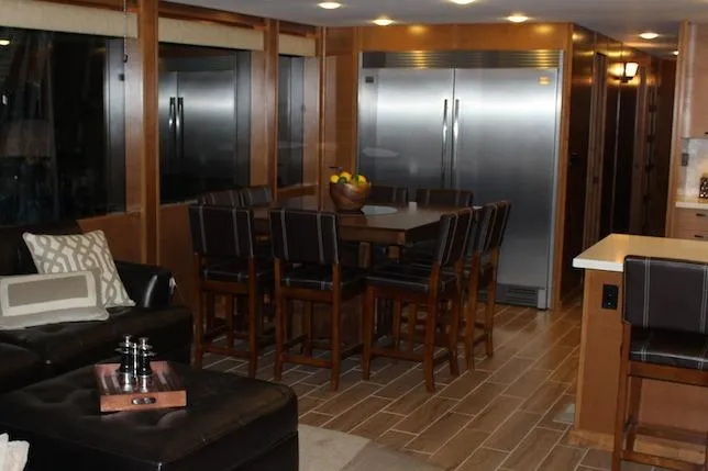 Slide: The Image of Luxurious black leather sectional sofa with decorative pillows and a wooden tray on the ottoman. - 7