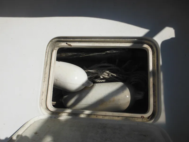 Slide: The Image of Storage compartment on 1985 Blackfin 29 Combi boat with ropes and fenders. - 16