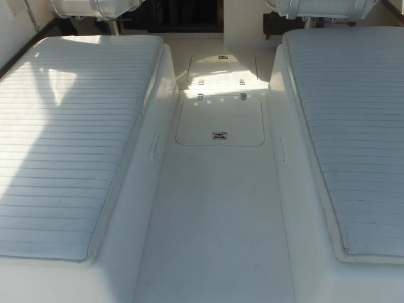 Slide: The Image of 1985 Blackfin 29 Combi boat interior with cushioned seating and storage compartments. - 19