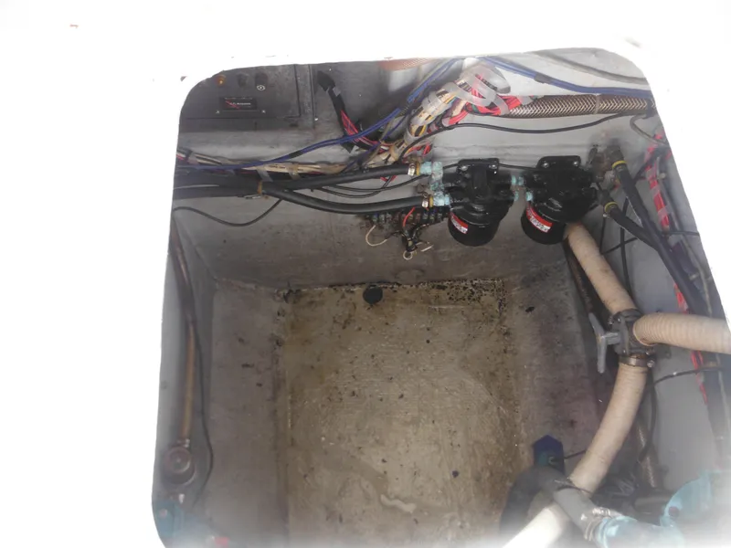 Slide: The Image of 1985 Blackfin 29 Combi engine compartment with wiring and hoses. - 22