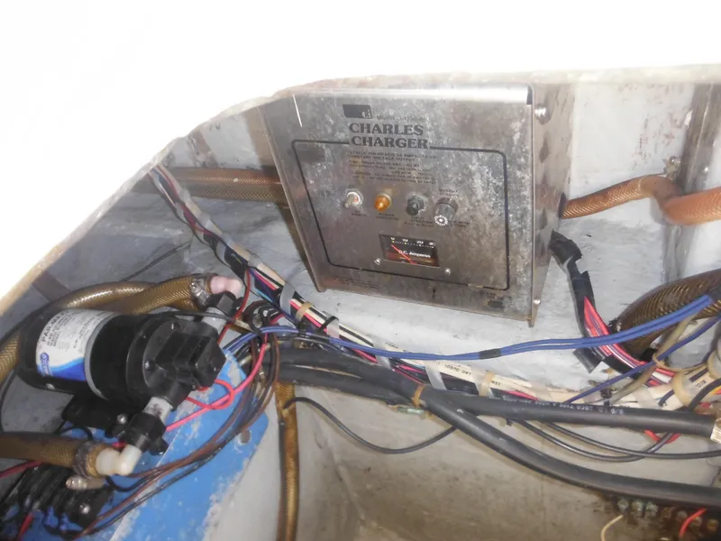Slide: The Image of 1985 Blackfin 29 Combi engine compartment with Charles Charger and wiring. - 23