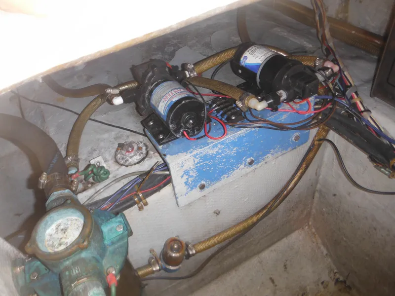 Slide: The Image of 1985 Blackfin 29 Combi engine compartment with wiring and pumps. - 24