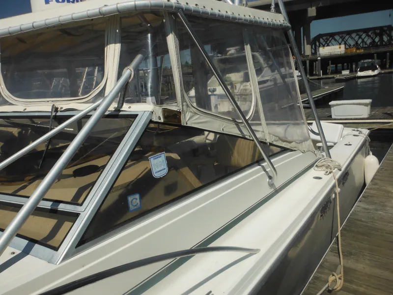 Slide: The Image of 1985 Blackfin 29 Combi boat docked at a marina, side view. - 37