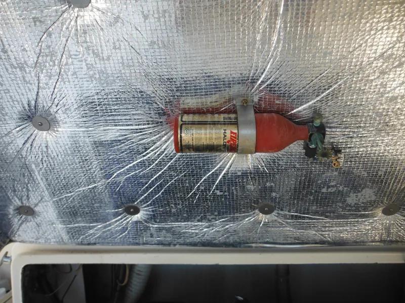 Slide: The Image of Fire extinguisher mounted on 1985 Blackfin 29 Combi boat with reflective insulation. - 39