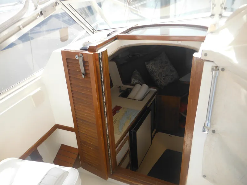 Slide: The Image of Interior cabin of 1985 Blackfin 29 Combi boat with wooden door and seating area. - 45