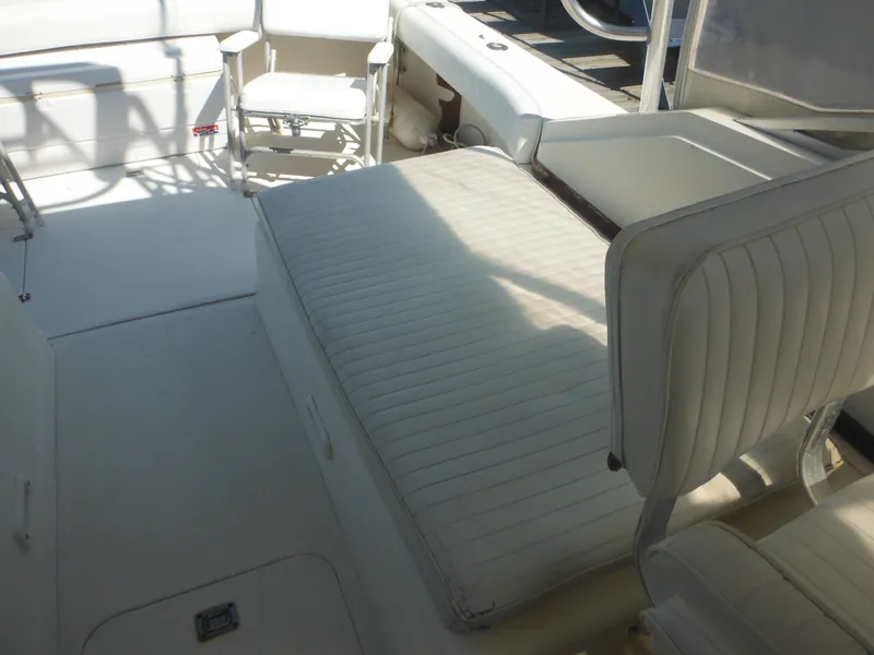 Slide: The Image of 1985 Blackfin 29 Combi boat interior with white cushioned seating. - 48