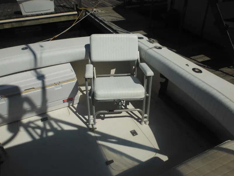 Slide: The Image of 1985 Blackfin 29 Combi boat deck with white captain's chair and storage box. - 6