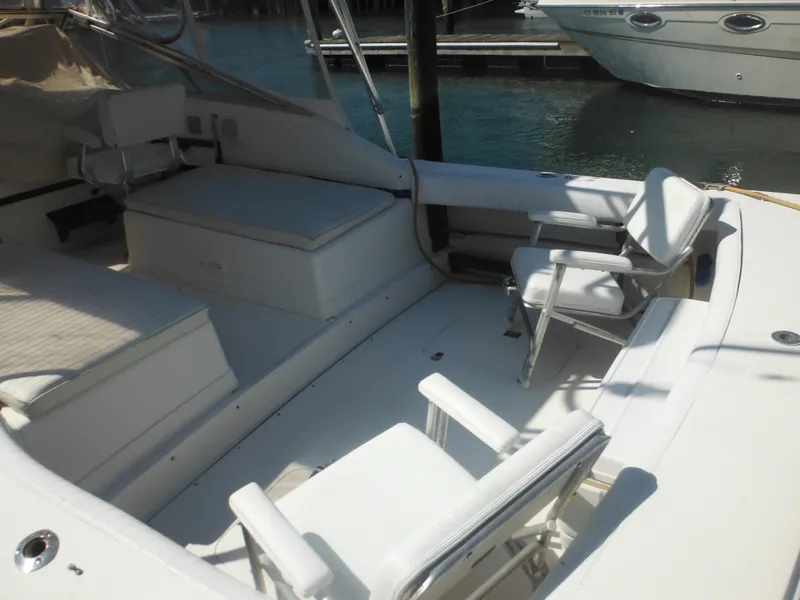 Slide: The Image of 1985 Blackfin 29 Combi boat interior with white seating and deck. - 9