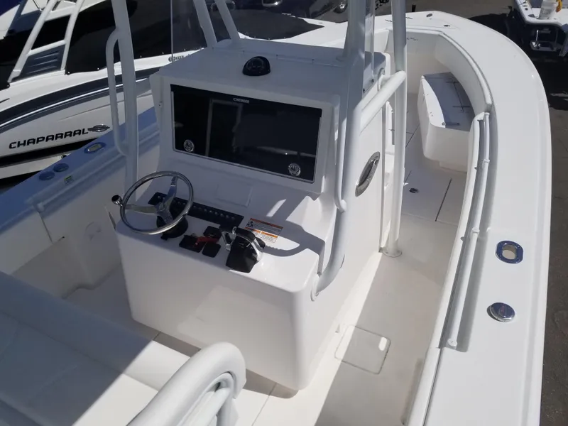 Slide: The Image of 2024 Contender 30 ST boat cockpit with steering wheel and control panel. - 2