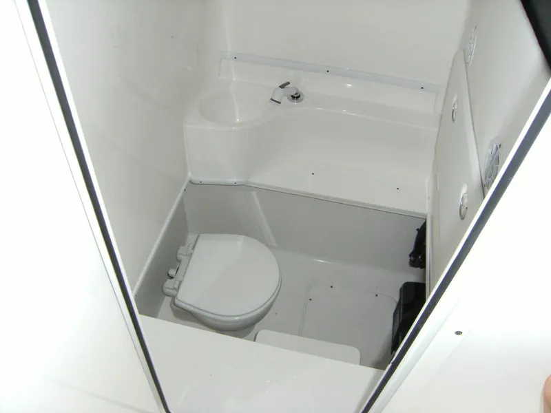 Slide: The Image of 2024 Contender 30 ST boat bathroom with toilet and sink. - 7