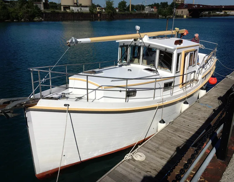 The Image of 2013 Diesel Duck 40 boat docked on a sunny day, featuring classic design and white hull. - 0