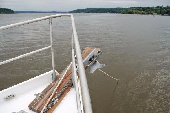 Slide: The Image of Bow of 2013 Diesel Duck 40 boat with anchor over calm water. - 21