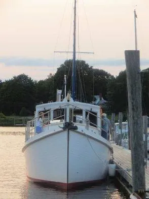 Slide: The Image of 2013 Diesel Duck 40 boat docked at sunset, front view. - 22