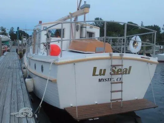 Slide: The Image of Diesel Duck 40 boat docked, named "Lu Seal," Mystic, CT, 2013 model. - 24