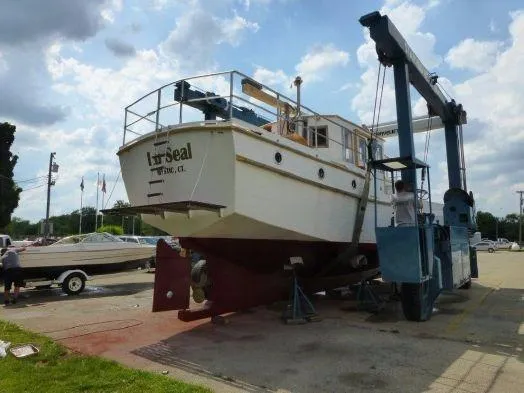 Slide: The Image of Diesel Duck 40 boat from 2013 on a lift at a marina. - 32