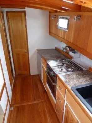 Slide: The Image of 2013 Diesel Duck 40 yacht kitchen with wooden cabinetry and modern appliances. - 37