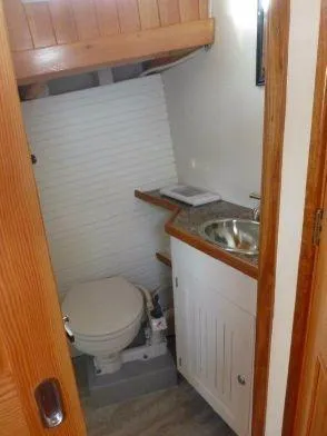 Slide: The Image of Diesel Duck 40 2013 boat bathroom with toilet, sink, and wooden accents. - 40