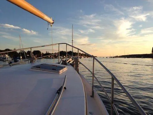 Slide: The Image of 2013 Diesel Duck 40 yacht on calm waters at sunset. - 41