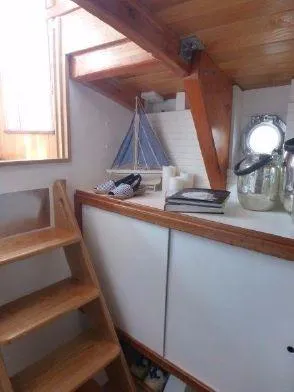 Slide: The Image of Interior of 2013 Diesel Duck 40 boat with wooden stairs and nautical decor. - 48