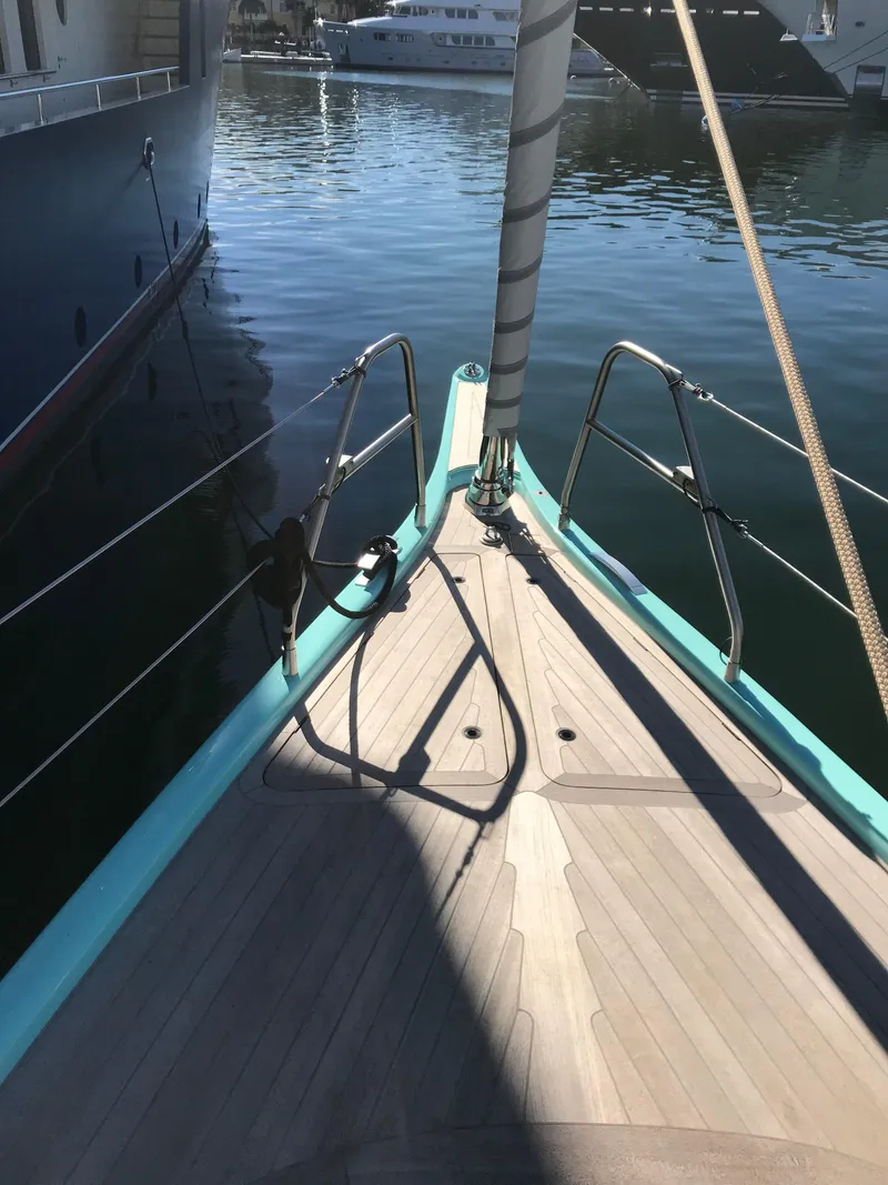 Slide: The Image of Bow of a 2025 Surfari 50 yacht docked in a marina. - 14