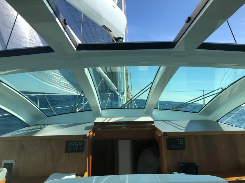 Slide: The Image of 2025 Surfari 50 yacht interior view with clear blue sky and ocean. - 17