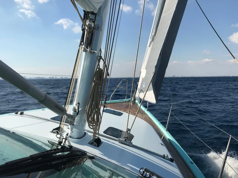 Slide: The Image of Sailing on a 2025 Surfari 50 yacht, open sea, clear skies, and gentle waves. - 19