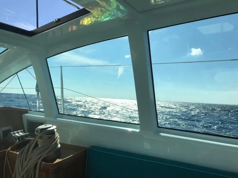Slide: The Image of View from inside a 2025 Surfari 50 yacht, overlooking the ocean through large windows. - 20