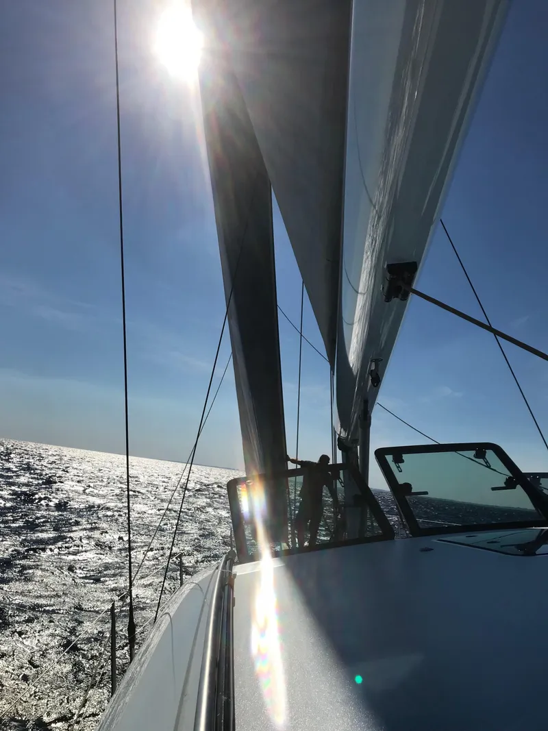 Slide: The Image of Sailing on a 2025 Surfari 50 yacht under bright sun and clear skies. - 21