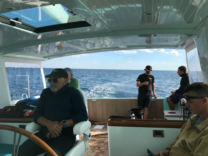 Slide: The Image of People enjoying a ride on a 2025 Surfari 50 yacht, with ocean views. - 22