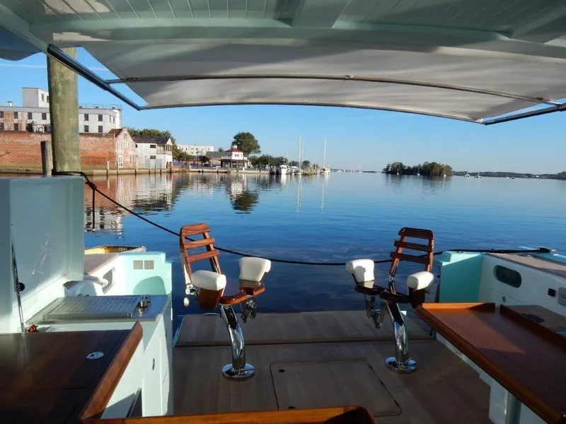 Slide: The Image of Luxurious 2025 Surfari 50 yacht interior with waterfront view and elegant seating. - 23