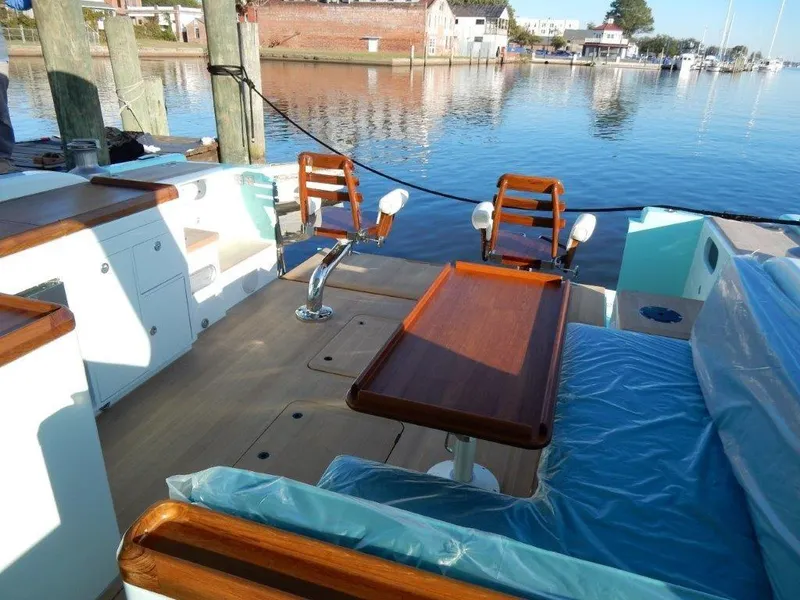 Slide: The Image of Luxurious 2025 Surfari 50 yacht interior with wooden accents and waterfront view. - 28