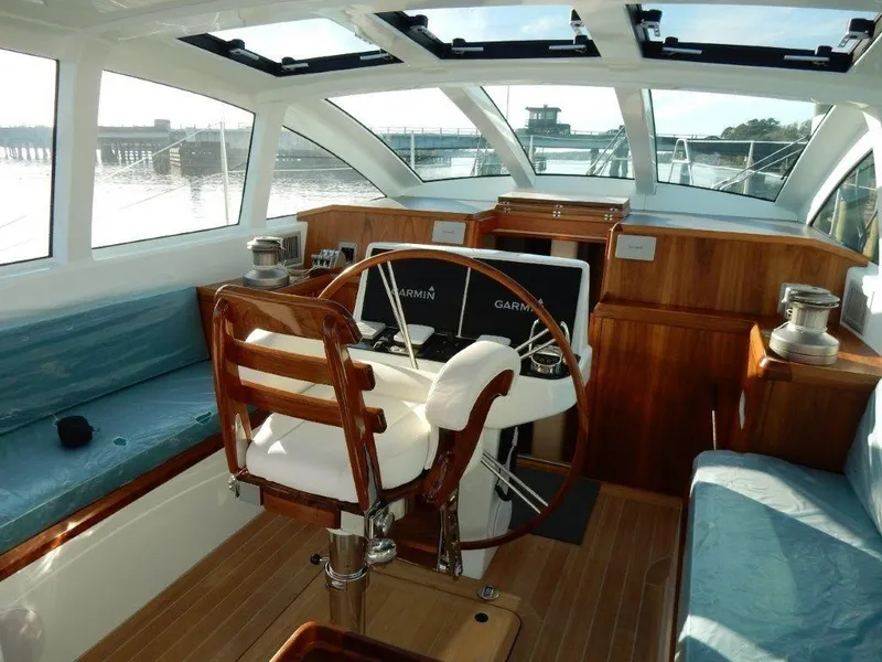 Slide: The Image of Luxurious 2025 Surfari 50 yacht interior with wooden helm and panoramic windows. - 30