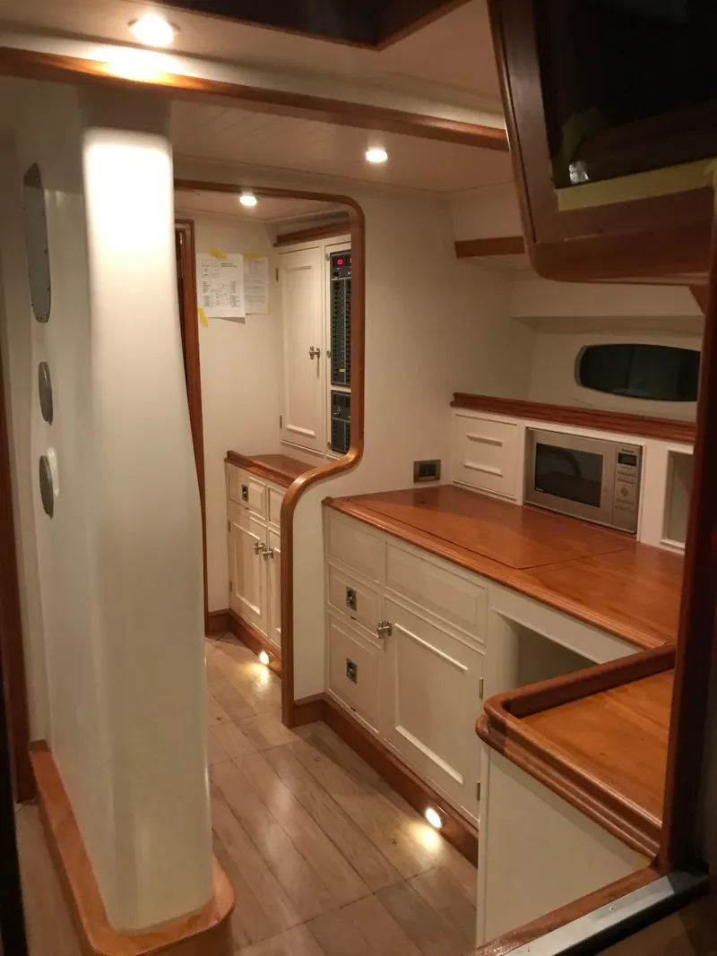 Slide: The Image of Luxurious interior of 2025 Surfari 50 yacht with modern kitchen and wooden accents. - 37