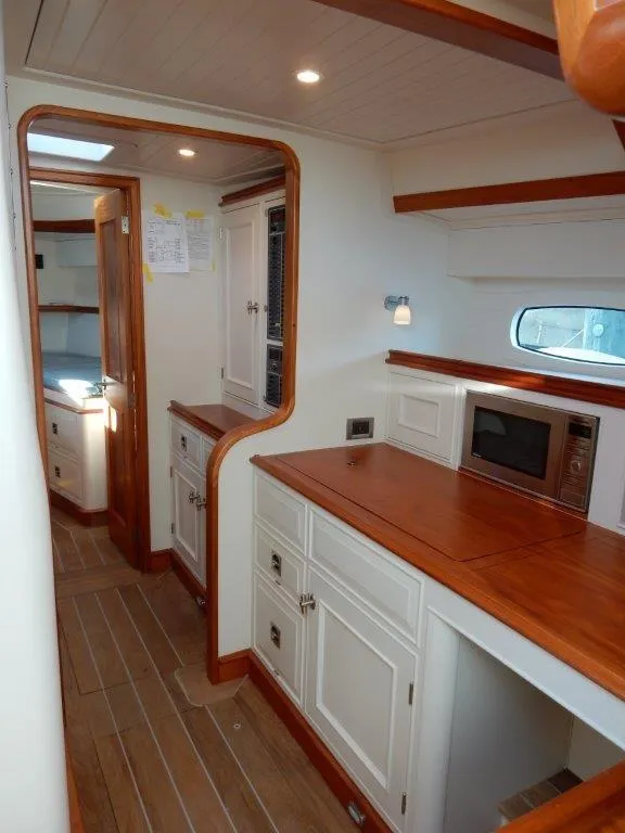 Slide: The Image of Luxurious interior of 2025 Surfari 50 yacht with modern kitchen and wooden finishes. - 41