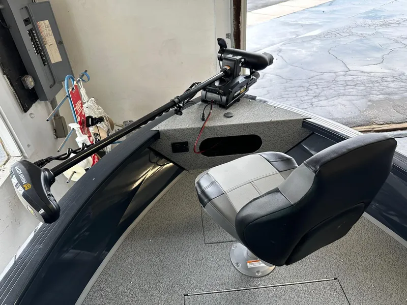 Slide: The Image of 2025 Crestliner 2050 Commander boat interior with swivel seat and trolling motor. - 2