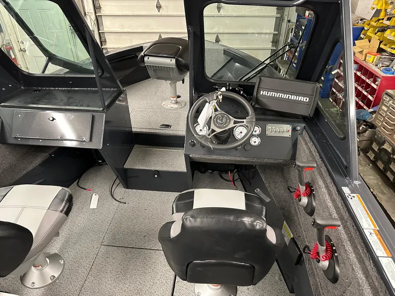 Slide: The Image of 2025 Crestliner 2050 Commander boat interior with steering console and seating. - 4