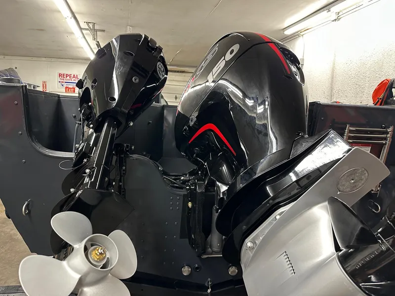 Slide: The Image of 2025 Crestliner 2050 Commander boat with powerful outboard motors in a garage. - 5