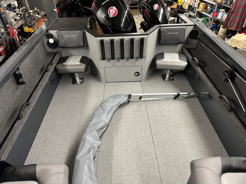 Slide: The Image of 2025 Crestliner 2050 Commander boat interior with seating and storage. - 8