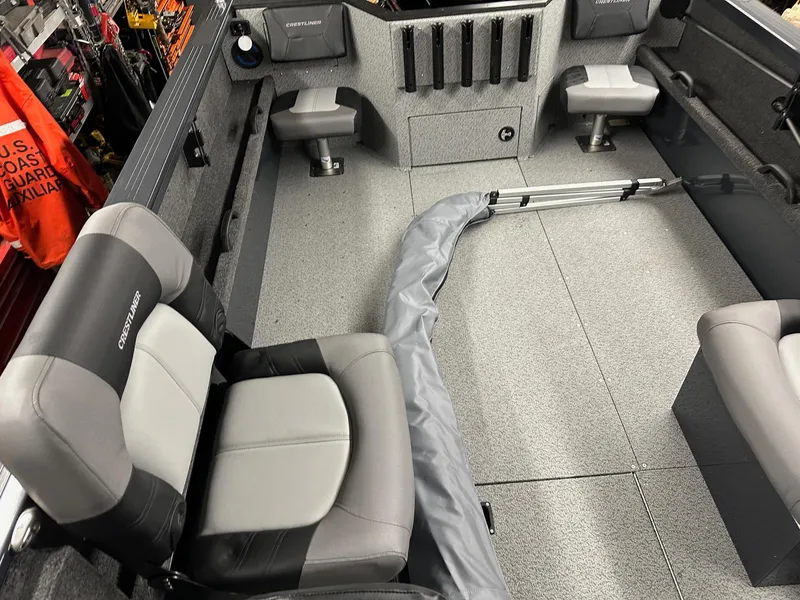 Slide: The Image of Interior of 2025 Crestliner 2050 Commander boat with seating and storage compartments. - 9