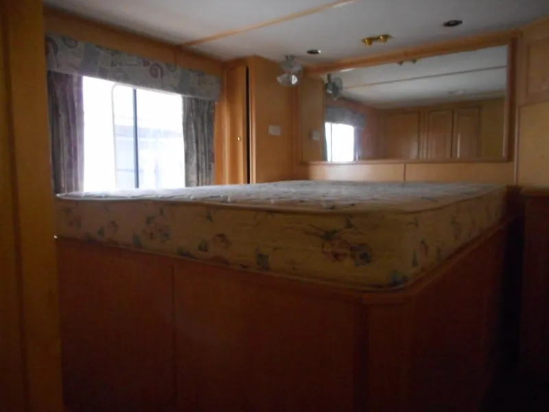 Slide: The Image of 2003 Stardust Cruisers Summer Haven Trip 33 bedroom with mattress and window. - 14