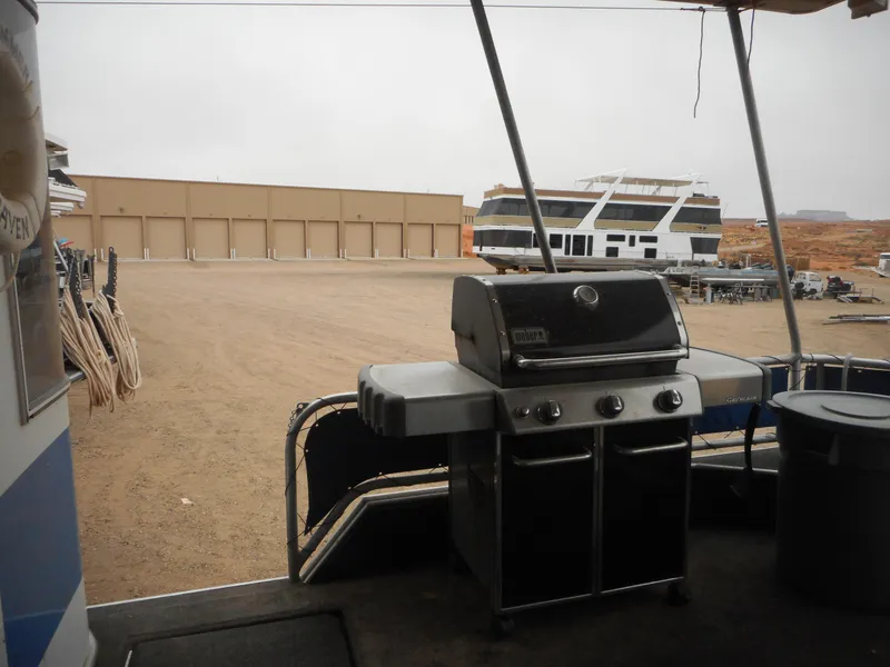 Slide: The Image of Outdoor view from a 2003 Stardust Cruisers Summer Haven Trip 33 houseboat with a grill. - 26